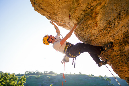 Image of tourist man in helmet clambering upの写真素材