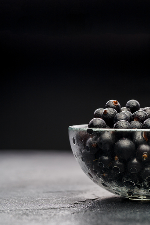 Image of black currant in glass transparent cupの写真素材