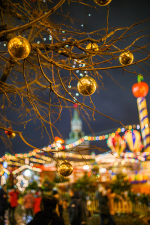 Picture of tree with golden balls on background of buildingの写真素材