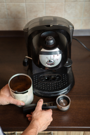 Coffee maker, mans hands holding coffee mugの写真素材
