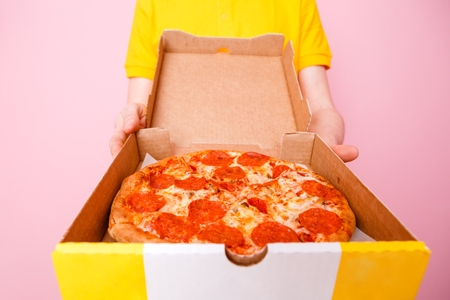 Pizza in box and courier handsの写真素材