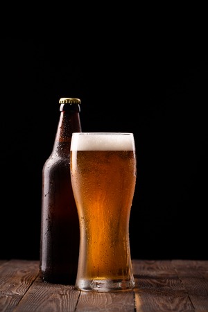 Photo of buttle and glass of beerの写真素材