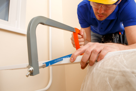 Image of joiner sawing wooden stickの写真素材