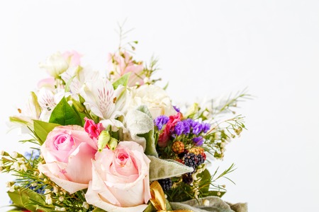 Photo of romantic bouquet of pink roses, lilies, green leaves on whiteの写真素材