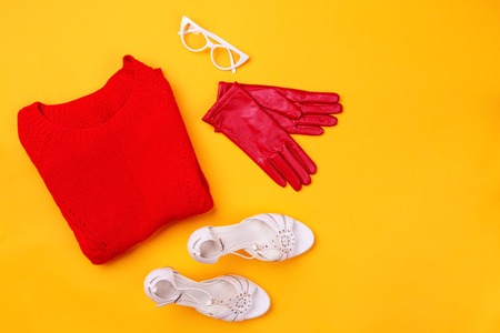 Top view of red swether, stylish shoes, red gloves and white glassesの写真素材