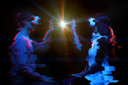 Couple of people communicate using a virtual reality headset. Image with glitch effect.の写真素材