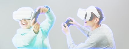 Man and woman with virtual reality headset are playing game. Image with hologram effect.の写真素材