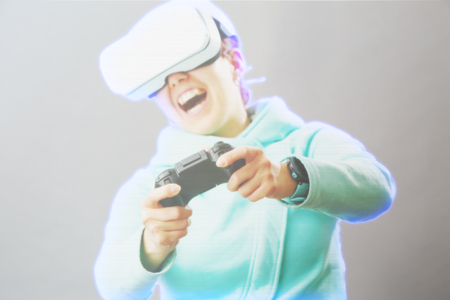 Woman with virtual reality headset is playing game. Image with hologram effect.の写真素材