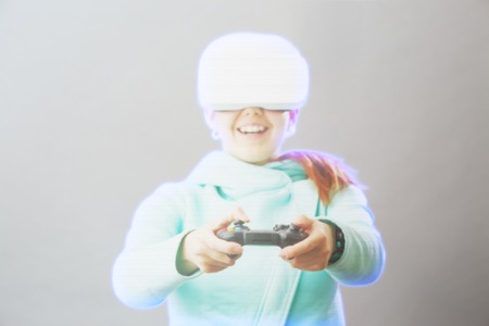 Woman with virtual reality headset is playing game. Image with hologram effect.の写真素材