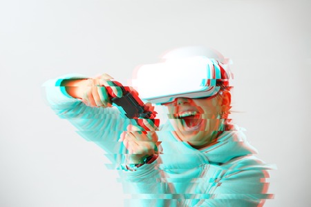 Woman with virtual reality headset is playing game. Image with glitch effect.の写真素材