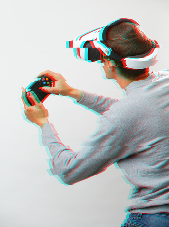 Man with virtual reality headset is playing game. Image with glitch effect.の写真素材