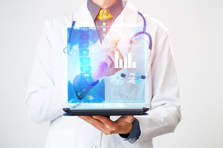 Doctor interacts with virtual screen of new technology for medicine.の写真素材