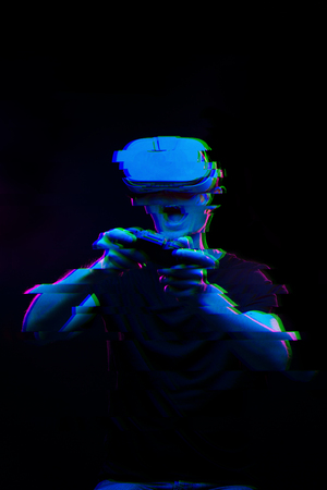 Man with virtual reality headset is playing game. Image with glitch effect.の写真素材