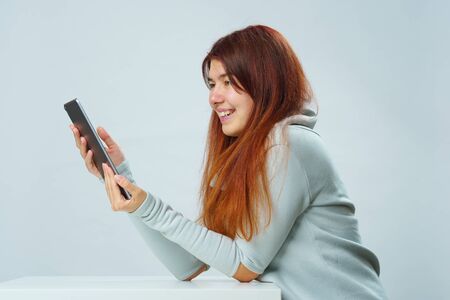 Woman is using tablet computer for communication in chat or video chat. Social media concept.
