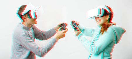 Man and woman with virtual reality headset are playing game. Image with glitch effect.