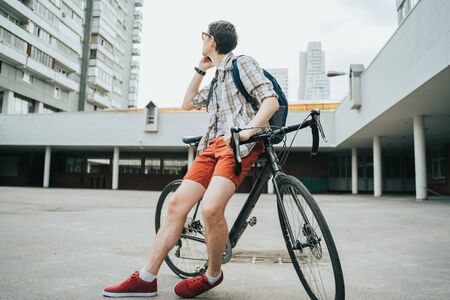 Man posing next to his bicycle.の写真素材