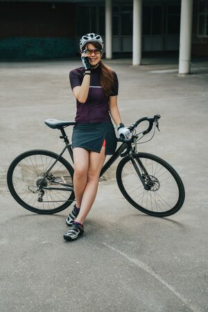 Man posing next to his bicycle.の写真素材