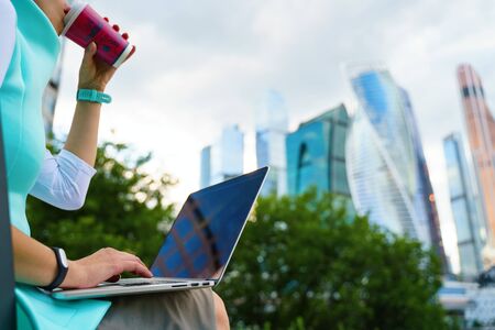 Close up cropped photo of business woman sitting with laptop