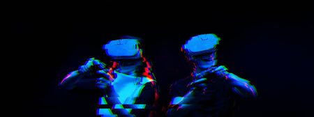 Couple with virtual reality headset are playing game. Image with glitch effect.