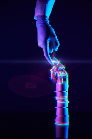 Touching fingers of engineer and digital technology that he creates. Acquaintance of man and...
