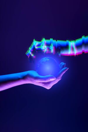 Woman and robots hands as symbol of partnership between people and technology.の写真素材