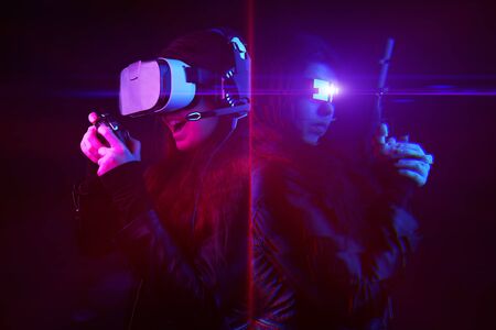 Woman with virtual reality headset and gamepad and his virtual gaming avatar. Image with glitch...