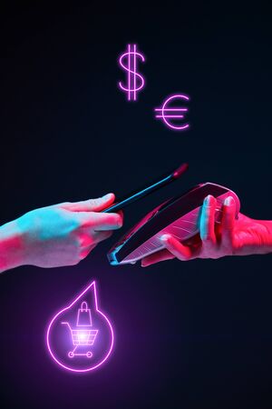 Payment transaction with smartphone. Modern neon color. Concept of online or wireless payments.の写真素材
