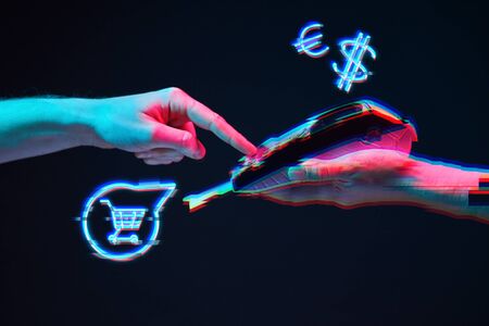 Wireless payment card via pin pad. Online wireless shopping concept in modern neon color. Image with glitch effectの写真素材
