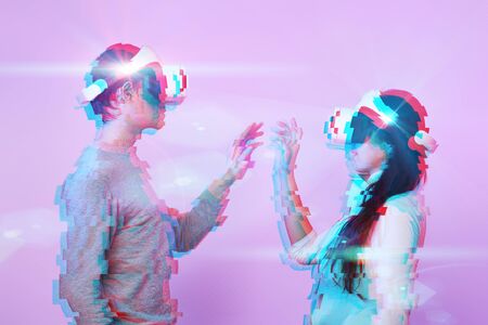 Couple in love communicate using a virtual reality headset. Image with glitch effect. Concept of...