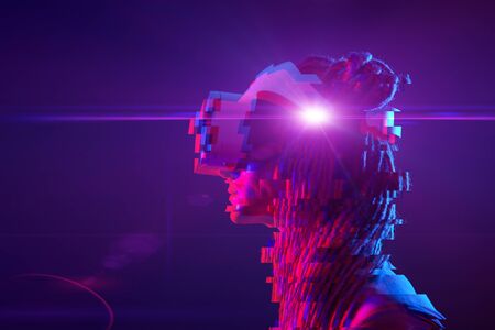 Woman is using virtual reality headset. Neon light studio portrait. Concept of virtual reality,...