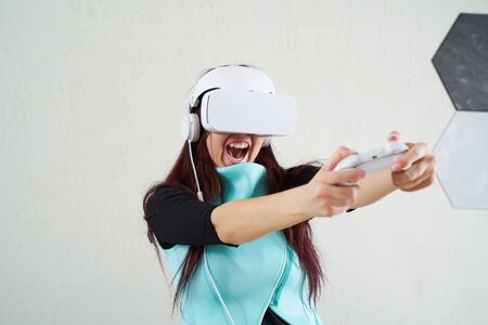 Woman with virtual reality headset is playing game.の写真素材