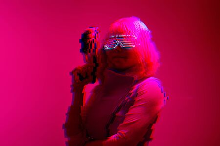 Girl with blaster in the futuristic battle. Concept virtual reality, cyber game. Image with glitch...