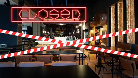 Closed due to pandemic. Premises of cafe are covered with red and white ribbon.の写真素材