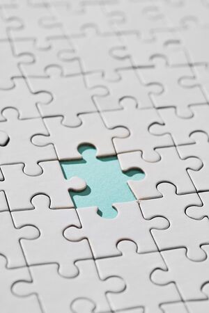 Blue background with white puzzle, wich piece is missing