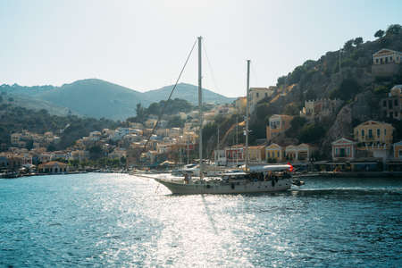 Greek island of Symi, Dodecanese, Greece - July 2019: Panoramic view of the coast the island of Symiのeditorial素材