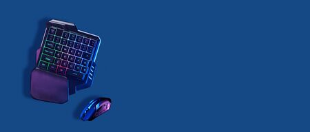Games keyboard and mouse on blue background.の写真素材