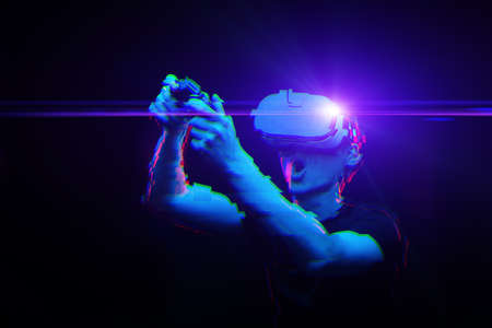 Man with virtual reality headset is playing game. Image with glitch effect. Concept of virtual reality, games, entertainment and communication.の写真素材