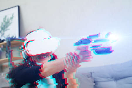 Woman with virtual reality headset is playing game. Image with glitch effect. Concept of virtual...