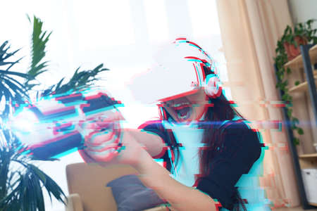 Woman with virtual reality headset is playing game. Image with glitch effect.