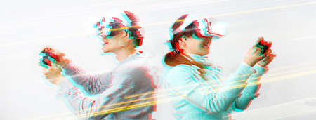 Man and woman with virtual reality headset are playing game. Image with glitch effect. Concept of virtual reality, games and communication.の写真素材