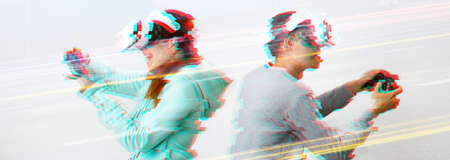 Man and woman with virtual reality headset are playing game. Image with glitch effect. Concept of virtual reality, games and communication.の写真素材