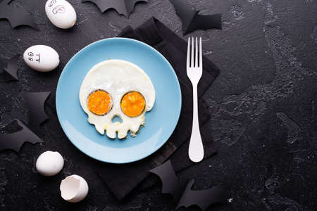 Fried eggs in the shape of a skull. Halloween breakfast.