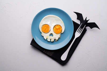 Fried eggs in the shape of a skull. Halloween breakfast.の写真素材