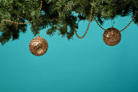 Christmas tree branch with stars, balls and garland.