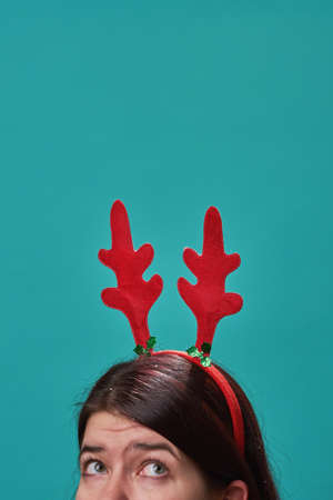 Woman in a headband with deer antlers.の写真素材