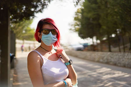 Woman wearing a face pollution mask to protect himself from the coronavirus