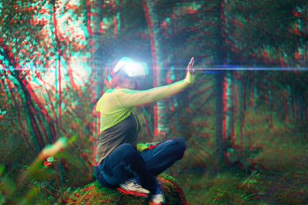 Woman goes into virtual reality using virtual reality headset. Image with glitch effect.の写真素材