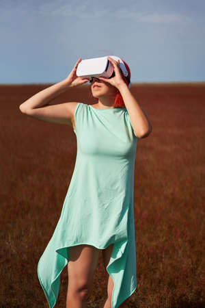 Woman goes into virtual reality using virtual reality headset.の写真素材