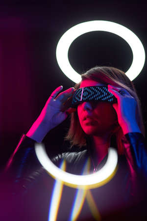 Cyberpunk style portrait of beautiful young woman in futuristic costume.