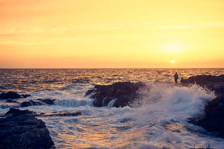 Splashes from the waves bumping against the rocky shore